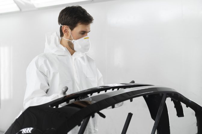 male-painter-hazmat-suit-inside-car-shop (1)