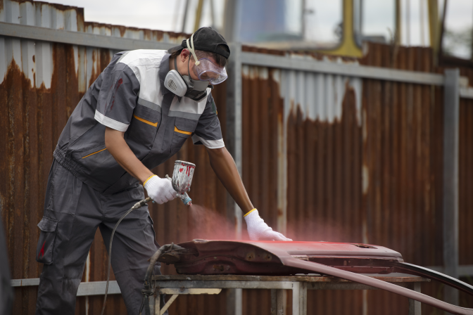 man-painting-car-door-side-view